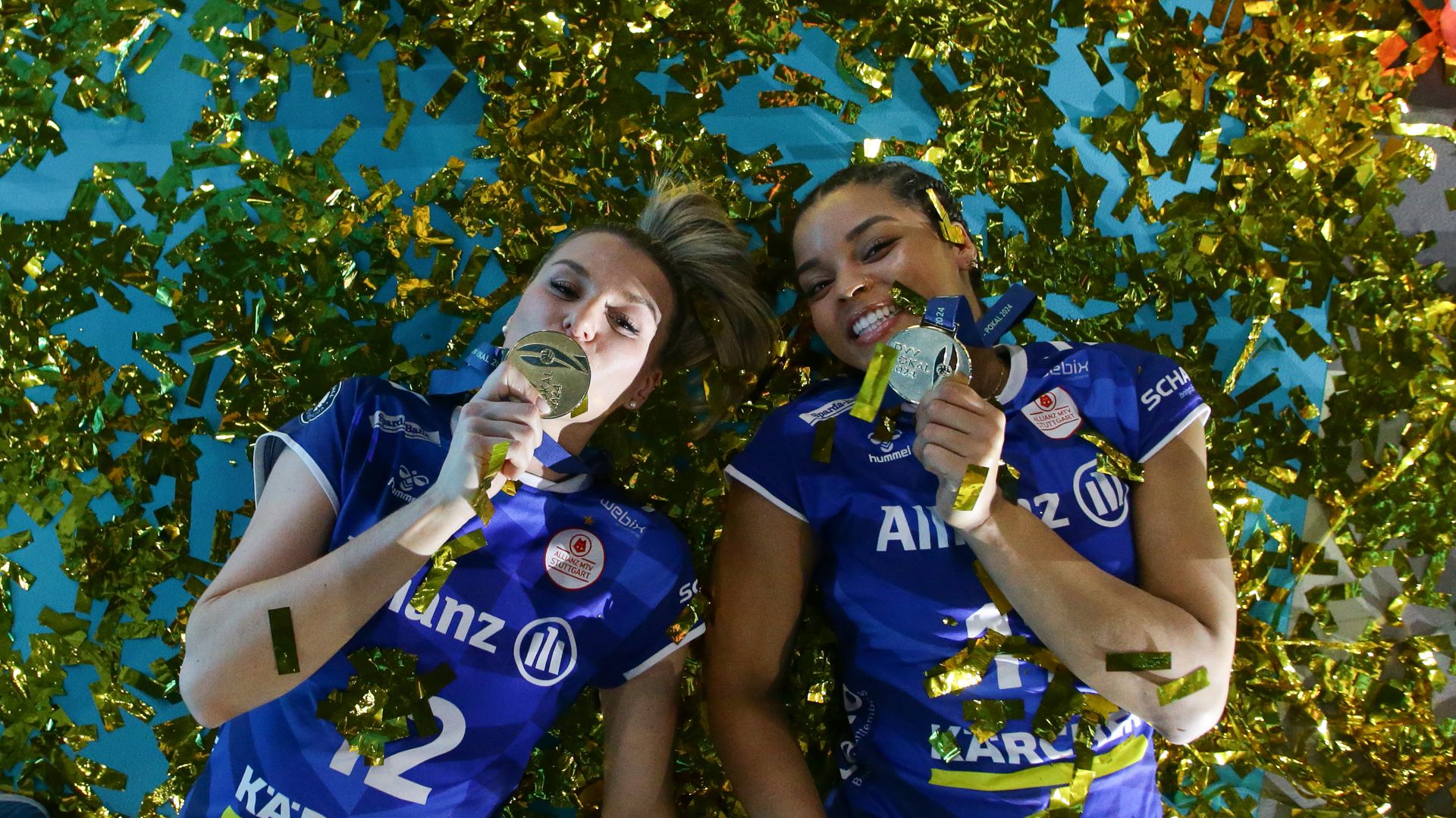 Alexis Lexi Hart and a teammate celebrating with championship medals in gold confetti